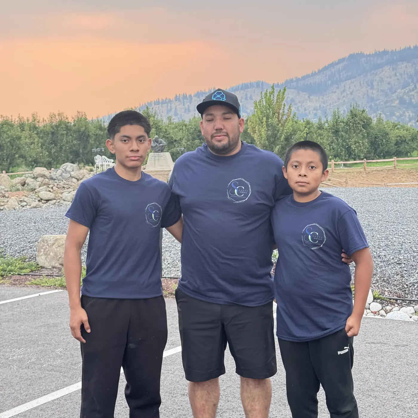 Three people wearing SC Event Rentals shirts outdoors