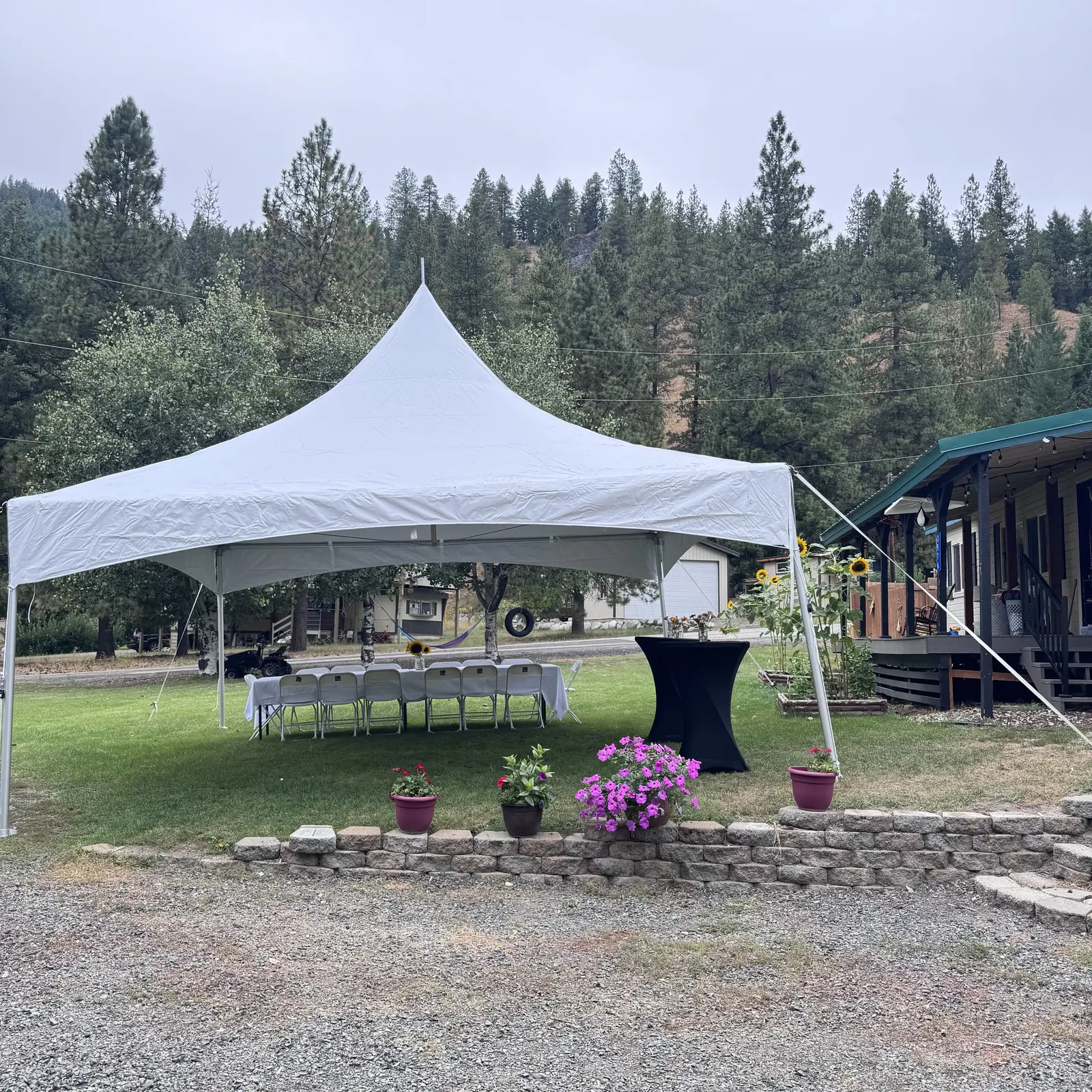 A large white event tent on a lawn